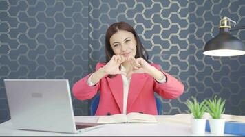 Young business woman making heart at camera. video