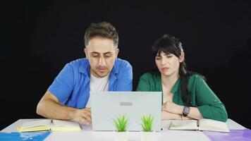 The couple who cannot use the application on the laptop. video