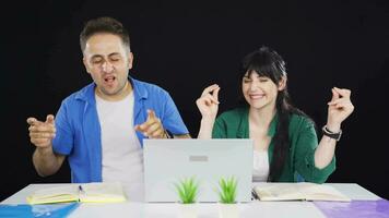 Dancing couple looking at laptop. video