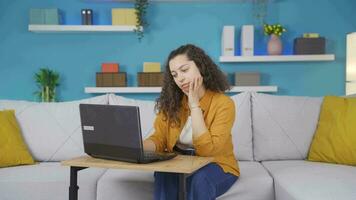 Young woman looking at laptop is thoughtful. video