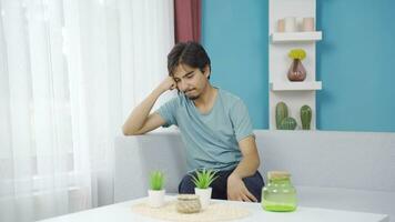 Happy and peaceful man. He is sitting in front of the window. video