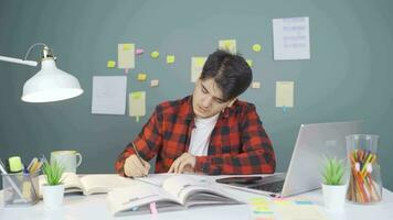 The male student who finishes the homework is happy and peaceful. video