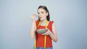 The person who has a hard time dieting. She eats little and is unhappy. video