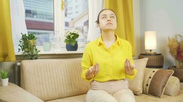 Muslim woman praying in front of the window. video