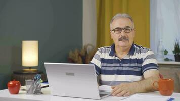 Home office worker man getting good news from camera. video