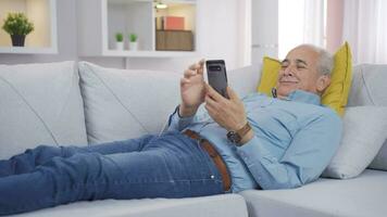 Man lying on the sofa is resting. video