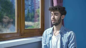 Christian man praying in front of the window. video