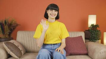 Happy woman waving at camera. video