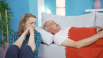 Thoughtful woman at the bedside of her sick husband. Sad. video