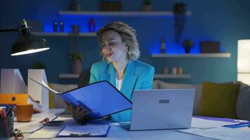 Home office worker woman looking at paperwork files. video