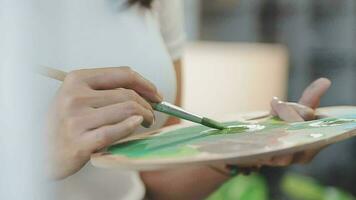 Attractive young woman attending a painting workshop, having fun, create an inspired art work at art studio video