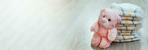 Diapers with a pink teddy bear. Hygiene of newborns. photo