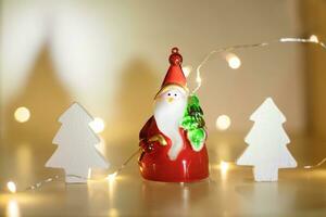 Santa Claus with a Christmas tree on the background of garland lights. Christmas background. Christmas background with bokeh from garlands. photo