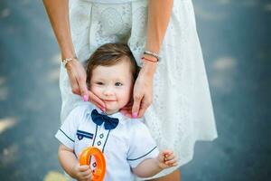 Mother holding little son on the cheek photo