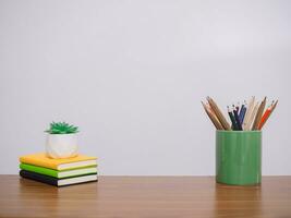 Office desk table, Student creative desktop with colorful stationery, hardcover book, potted cactus. Copy space for text, Back to school, Education concept photo