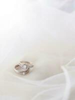 Wedding accessories. Diamond engagement wedding rings on white box. Valentine's day and Wedding day concept. photo