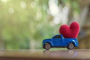 un juguete camión con un tejido a ganchillo corazón en parte superior foto