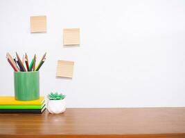 Office desk table, Student creative desktop with colorful stationery, hardcover book, potted cactus, sticky notes. Copy space for text, Back to school, Education concept photo