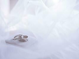 Wedding accessories. Diamond engagement wedding rings on white box. Valentine's day and Wedding day concept. photo