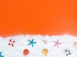 Top view of summer beach decoration on orange background, copy space for text photo