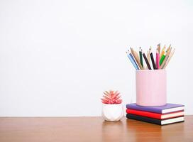 Office desk table, Student creative desktop with colorful stationery, hardcover book, potted cactus. Copy space for text, Back to school, Education concept photo