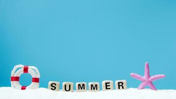 Summer word on white sand. Copyspace for text. Concept of summer photo