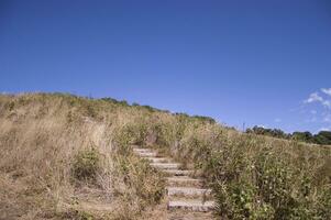 Walkway on hill at the mountain with blue sky photo