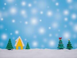 Christmas tree, Miniature house with shiny light for Christmas and New Year holidays background, Winter season, falling snow, Copy space for Christmas and New Year holidays greeting card. photo