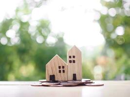 Miniature house on stack of coins. The concept of saving money for house, Property investment, House mortgage, Real estste. photo