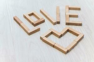 The word love built of wooden blocks on the floor photo