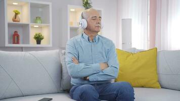 Man listening to music with headphones is unhappy and sad. video