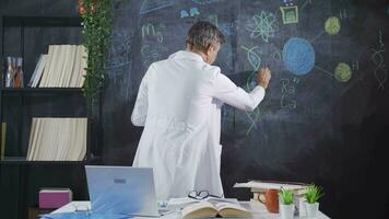 Scientist drawing autism DNA helix on blackboard. video