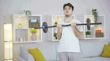 Man working out his arm muscles using barbell. video