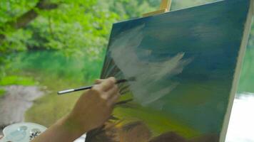 detailopname schilder schilderij een afbeelding door de meer. video