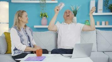 The couple counting money at home rejoices. High income couple. video