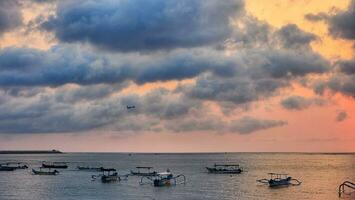 Fishing boats in the sea at sunrise. Beautiful sky with clouds. photo