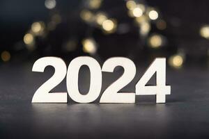 2024 wooden numbers with bokeh background. Happy new year 2024 concept photo
