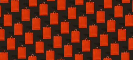 Black friday sale, shopping concept. Red paper shopping bag pattern on black background. photo