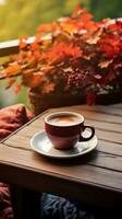 taza de café en de madera mesa con otoñal hojas en antecedentes. ai generativo. foto