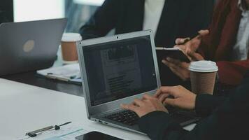 multietnico gruppo di contento attività commerciale persone Lavorando insieme, incontro e di brainstorming nel ufficio utilizzando computer, computer portatile, tavoletta, e mobile Telefono. video