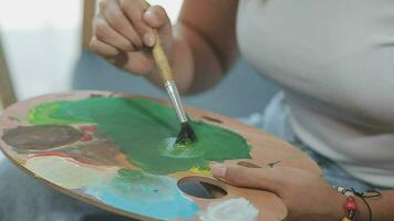 Attractive young woman attending a painting workshop, having fun, create an inspired art work at art studio video