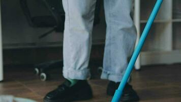 Housewife using vacuum cleaner on the floor. Wearing an apron to clean the living room at house. Young woman is happy to clean home. Maid cleaning service. video