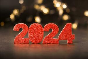 2024 Brillantina rojo números con bokeh antecedentes. contento nuevo año 2024 concepto. foto