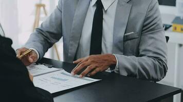Home buyers meet and negotiate with real estate agents about renting or buying a home in the office. video