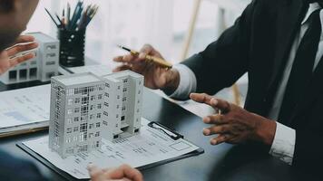 Home buyers meet and negotiate with real estate agents about renting or buying a home in the office. video