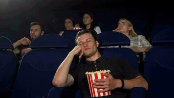 Handsome man falling asleep during movie at the cinema video