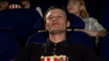 Happy attractive man smiling to the camera at the cinema video