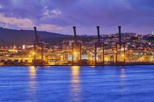 View of Lisbon port with port cranes in the evening photo