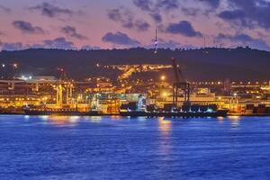 View of Lisbon port with port cranes in the evening photo