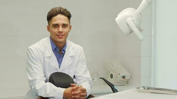 Handsome professional dentist posing at his office video